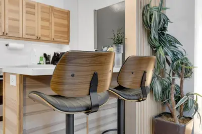two chairs sitting next to a counter in a kitchen at The Sherbrooke Suite 99 in Montréal