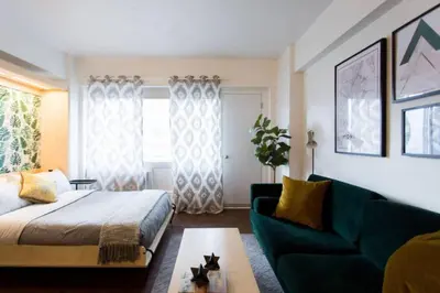 a living room with a bed and a couch at The Sherbrooke Suite 103 in Montréal