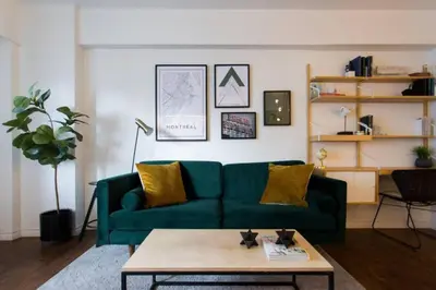 a living room with a green couch and a coffee table at The Sherbrooke Suite 103 in Montréal