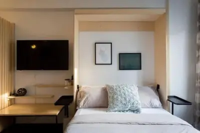 a bedroom with a bed and a flat screen tv at The Sherbrooke Suite 102 in Montréal