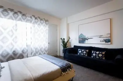 a bedroom with a bed and a couch at The Sherbrooke Suite 102 in Montréal