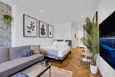 a living room with a bed and a couch at The Speakeasy Suite 502 With Parking in Montréal