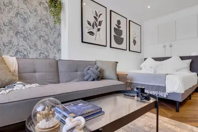 a living room with a couch and a bed at The Speakeasy Suite 502 With Parking in Montréal