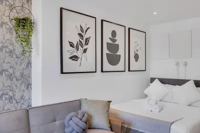a living room with a couch and four pictures on the wall at The Speakeasy Suite 502 With Parking in Montréal