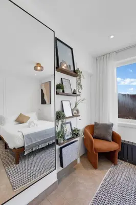 a bedroom with a mirror and a bed and a chair at The Speakeasy Suite 501 With Parking in Montréal