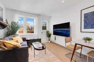 a living room with a couch and a table at The Speakeasy Suite 501 With Parking in Montréal