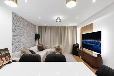 a living room with a couch and a tv at Atelier Montreal Luxe 1BR King Bed With Parking in Montréal