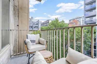 a balcony with a chair and a table at Atelier Montreal Luxe 1BR King Bed With Parking in Montréal