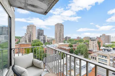 a balcony with a couch and a view of the city at Downtown Montreal Horizon Suite With Parking in Montréal