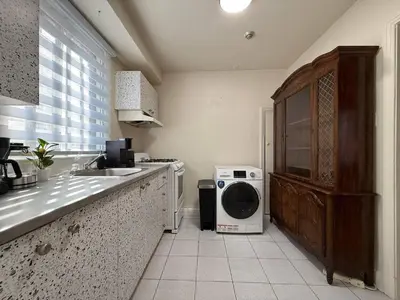 a kitchen with a sink and a washing machine at Delightful Style & Comfort in Montreal! Sleep 4! in Montréal