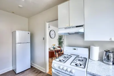 a kitchen with a stove and a white refrigerator at Delightful Style & Comfort in Montreal! Sleep 4! in Montréal