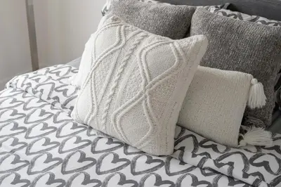 a pile of pillows on a bed with at Cozy Oasis Home Downtown Montreal - Free Indoor Parking-In Suite Laundry in Montréal