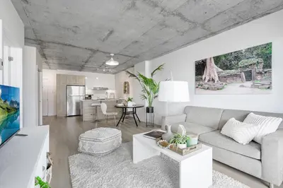 a living room with a couch and a table at Cozy Oasis Home Downtown Montreal - Free Indoor Parking-In Suite Laundry in Montréal