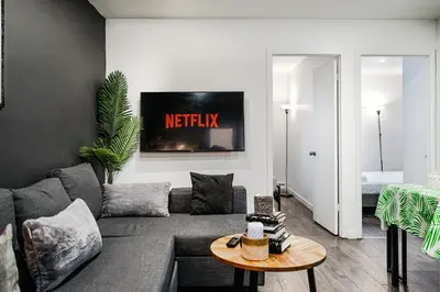 a living room with a couch and a table at Appartement design au cœur de Griffintown in Montréal
