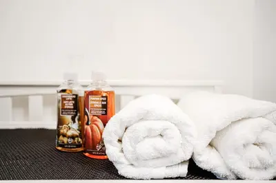 a pile of towels and two bottles of honey and pumpkins at Appartement design au cœur de Griffintown in Montréal