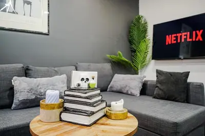 a pile of books on a coffee table in a living room at Appartement design au cœur de Griffintown in Montréal