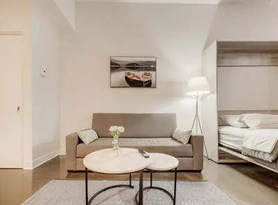 a living room with a couch and a table at Confort et style en plein Montréal in Montréal
