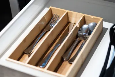 a wooden tray with utensils sitting on a table at Confort et style en plein Montréal in Montréal