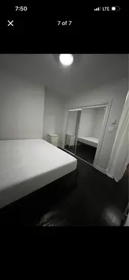 a bedroom with a white bed and a mirror at Mont roamyal in Montréal