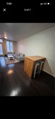 a living room with a table and a couch at Mont roamyal in Montréal