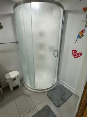 a shower with a glass door in a bathroom at Appartement Cool à Longueuil Plan A in Longueuil