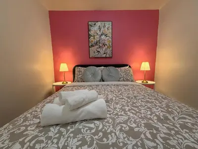 a bedroom with a large bed with two lamps at Lovely Vacation Home 2BR in MTL! in Montréal