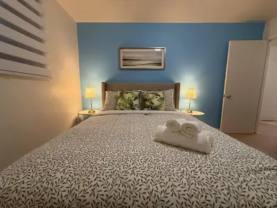 a bedroom with a large bed with two towels on it at Lovely Vacation Home 2BR in MTL! in Montréal