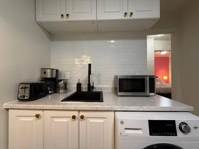 a kitchen counter with a sink and a microwave at Lovely Vacation Home 2BR in MTL! in Montréal