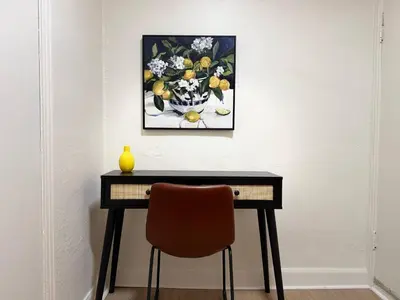 a desk with a chair and a picture of flowers at Lovely Vacation Home 2BR in MTL! in Montréal