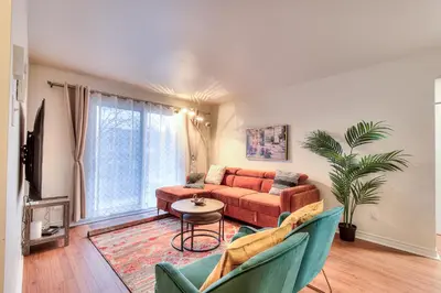 a living room with a couch and a table at Free Parking! Montreal Adventure Home - Modern & Spacious Comforts! in Montréal