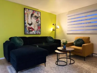 a living room with a couch and a table at Free Parking! Montreal Adventure Home - Modern & Spacious Comforts! in Montréal