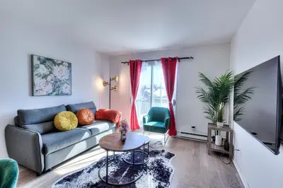 a living room with a couch and a tv at Montreal & Free Parking Comfy Cozy Pierrefonds Apts in Montréal