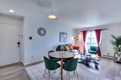 a living room with a table and chairs at Montreal & Free Parking Comfy Cozy Pierrefonds Apts in Montréal