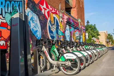 a row of bikes parked in front of a wall at Montreal & Free Parking Comfy Cozy Pierrefonds Apts in Montréal