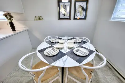 a dining room with a white table and chairs at Free Parking! Family & Travel Comforts! Montreal & Downtown Adventures! in Montréal