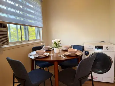 a dining room table and chairs with wine glasses at Free Parking! Family & Travel Comforts! Montreal & Downtown Adventures! in Montréal