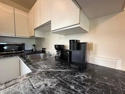 a kitchen with a black counter top and a sink at Free Parking! Family & Travel Comforts! Montreal & Downtown Adventures! in Montréal