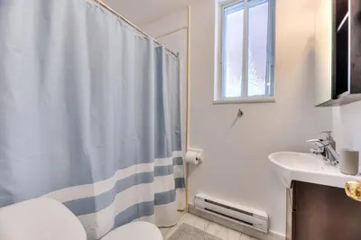 a bathroom with a shower curtain and a sink at NDG & Montreal getaway in Montréal