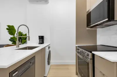 a kitchen with a sink and a dishwasher at Le Mistral Modern Studios in Montréal