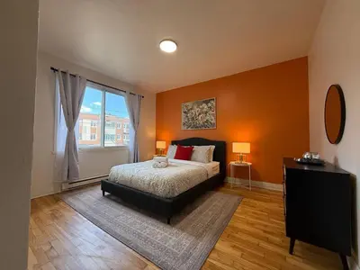 a bedroom with a bed and a large window at NDG Montreal! Attractions & Downtown Adventure Travels! Family, Friends, Work-travel! in Montréal