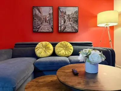 a living room with a blue couch and a table at NDG Montreal! Attractions & Downtown Adventure Travels! Family, Friends, Work-travel! in Montréal