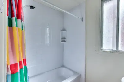 a bathroom with a colorful shower curtain next to a tub at NDG Montreal! Attractions & Downtown Adventure Travels! Family, Friends, Work-travel! in Montréal