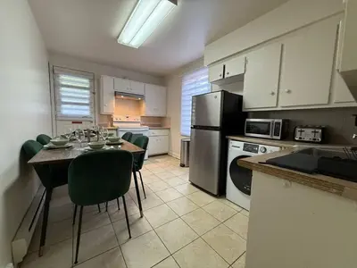 a kitchen with a table and chairs in a kitchen at Your Montreal Home Base! Free parking Free Wifi in Montréal