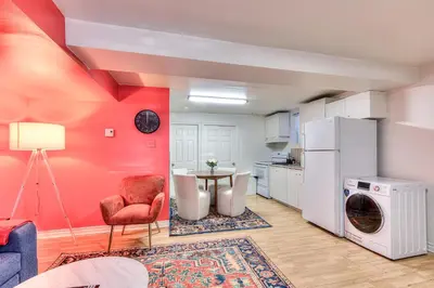 a living room with a table and a refrigerator at Your Montreal Home Base! Free parking Free Wifi in Montréal