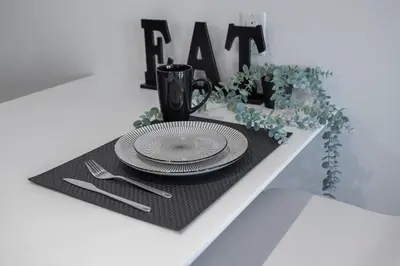 a table with a plate on a black placemat at Panoramic Skyline Penthouse Montreal Downtown -Free Parking - In Suite Laundry in Montréal