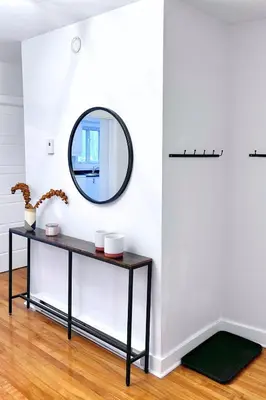a mirror on a wall in a room with a table at Riverside stay, 2 bedrooms, 1 office, free parking in Montréal