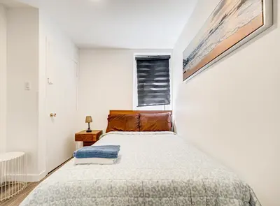 a bedroom with a bed and a window at Appartement design au cœur de Griffintown in Montréal