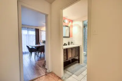 a bathroom with a sink and a table with a mirror at Free Parking! Montreal Comfort Value Convenience! Full Kitchen, Fast Wifi, Workspace, Smart TV! in Montréal