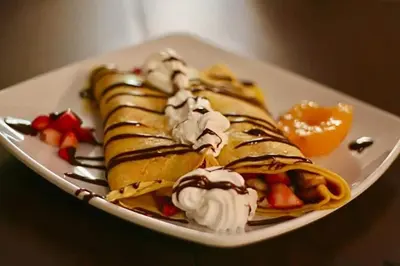 a plate of waffles with ice cream and fruit at Free Parking! Montreal Comfort Value Convenience! Full Kitchen, Fast Wifi, Workspace, Smart TV! in Montréal
