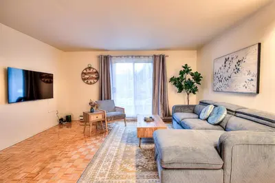 a living room with a couch and a table at Free Parking! Montreal Comfort Value Convenience! Full Kitchen, Fast Wifi, Workspace, Smart TV! in Montréal